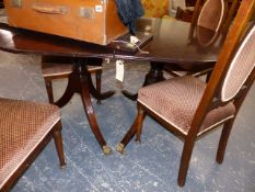 A MAHOGANY DINING TABLE.