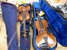 TWO VINTAGE VIOLINS AND FOUR BOWS.