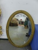 A GILT FRAMED MIRROR.