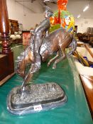 A BRONZE FIGURE BUCKING BRONCO.