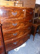 A VICTORIAN FLAME MAHOGANY BOW FRONT CHEST OF TWO SHORT AND THREE LONG GRADUATED DRAWERS.