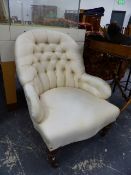 A PAIR OF VICTORIAN BUTTON BACK ARMCHAIRS.