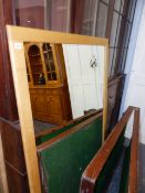 A LARGE OAK FRAMED MIRROR.