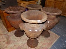 A SET OF FOUR CAST IRON GARDEN URNS.