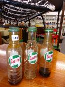 THREE RARE CASTROL OIL BOTTLES WITH LIDS.