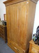 A VICTORIAN PINE WARDROBE.