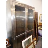 A LARGE BRUSHED STEEL DISPLAY CABINET.