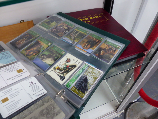 A QTY OF PHONE CARDS AND COLLECTOR'S CARDS.
