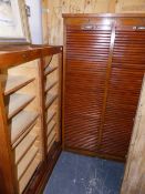 TWO TAMBOUR FRONT CABINETS.