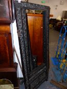 AN ORIENTAL CARVED HARDWOOD SCREEN FRAME.