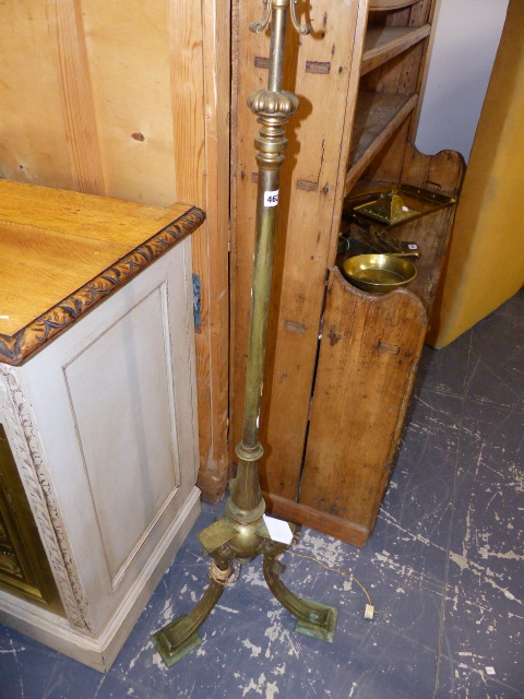 AN EDWARDIAN BRASS STANDARD LAMP.
