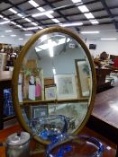 A GILT FRAMED EASEL BACK MIRROR.