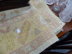 A HAND WOVEN PALE GROUND SMALL RUG.