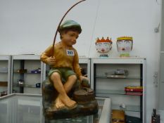 AN ART DECO FIGURE OF A BOY FISHING.