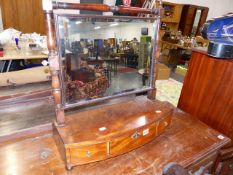 A LATE GEORGIAN MAHOGANY SWING MIRROR.