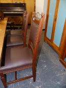 A SET OF SIX ARTS AND CRAFTS OAK DINING CHAIRS.