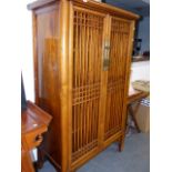 AN ORIENTAL ELM CABINET WITH LATTICE DOORS.