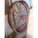 A PAIR OF VINTAGE CAST IRON WAGON WHEELS.