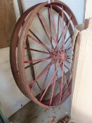 A PAIR OF VINTAGE CAST IRON WAGON WHEELS.