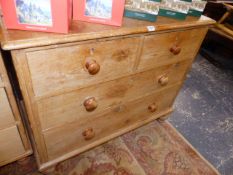 A VICTORIAN PINE CHEST OF TWO SHORT AND TWO LONG DRAWERS.