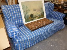 AN EDWARDIAN WING BACK THREE SEAT SETTEE.