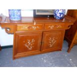 AN ORIENTAL HARDWOOD SIDE CABINET WITH MOTHER OF PEARL INLAY.