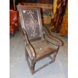 AN OAK WAINSCOT ARMCHAIR, CHEVRON BANDS ENCLOSING THE DIAMOND CARVED BACK PANEL, THE SEAT WITH