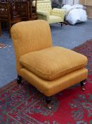 A BESPOKE GEORGE SMITH LTD LOW SLIPPER OR OTTOMAN CHAIR WITH LOOSE FEATHER CUSHION ON TURNED