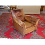 AN ART DECO LEATHER UPHOLSTERED CLUB ARMCHAIR.