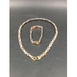 A 9ct THREE COLOUR GOLD NECKLACE AND BRACELET SET. NECKLACE LENGTH 43cms, BRACELET 19cms. GROSS