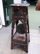 A MOORISH TWO TIER TABLE, THE TOP WITH RELIEF CARVED ROUNDEL WITHIN MOTHER OF PEARL FLOWER HEAD