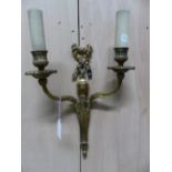 A PAIR OF ORMOLU TWO BRANCH WALL LIGHTS, THE FLUTED NOZZLES ON REEDED ARMS SCROLLING FROM RIBBON