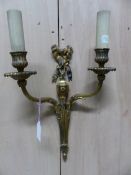 A PAIR OF ORMOLU TWO BRANCH WALL LIGHTS, THE FLUTED NOZZLES ON REEDED ARMS SCROLLING FROM RIBBON