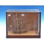 A MAHOGANY SCALE MODEL OF A THREE MASTED SHIP FLYING THE ROYAL NAVY WHITE ENSIGN AT ITS STERN AND IN