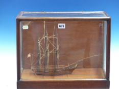 A MAHOGANY SCALE MODEL OF A THREE MASTED SHIP FLYING THE ROYAL NAVY WHITE ENSIGN AT ITS STERN AND IN