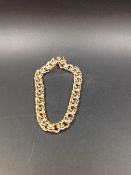 A 14CT GOLD DOUBLE INTERWOVEN SOLID CURB BRACELET, LENGTH 22cms, WEIGHT 47grms.