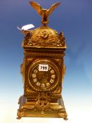 A BRASS CASED JAPY FRERES PENDULUM CLOCK STRIKING ON A COILED ROD, THE CASE SURMOUNTED BY A SPREAD