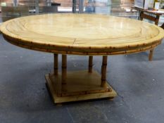 A FAUX MARBLE TOPPED CIRCULAR TABLE WITH PAINTED BAMBOO EDGE ABOVE FOUR BAMBOO COLUMNS AND SQUARE