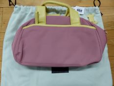 A RADLEY PINK TEXTILE HANDBAG WITH LIME LEATHER HANDLES AND EDGINGS, THE INTERIOR LINED WITH