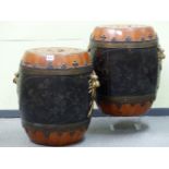 A PAIR OF BLACK LACQUERED WOOD BARREL SHAPED JARS, THE RED GROUND COVERS WITH CASH MEDALLION INSET