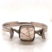 A SILVER GEORG JENSEN TORUN BANGLE MOUNTED WITH A LARGE RUTILATED QUARTZ STONE DESIGN NUMBER #207 BY
