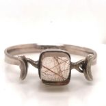 A SILVER GEORG JENSEN TORUN BANGLE MOUNTED WITH A LARGE RUTILATED QUARTZ STONE DESIGN NUMBER #207 BY