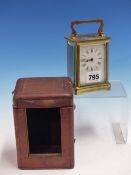 A LEATHER CASED CARRIAGE TIMEPIECE, THE GLAZED BRASS CASE. H 11.5cms.