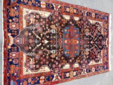 A PERSIAN TRIBAL RUG 275 x 170cms.