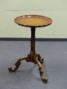 A BRASS GALLERIED MAHOGANY TWO TIER JARDINAIRE STAND THE FOUR CABRIOLE LEGS ENDING IN BRASS