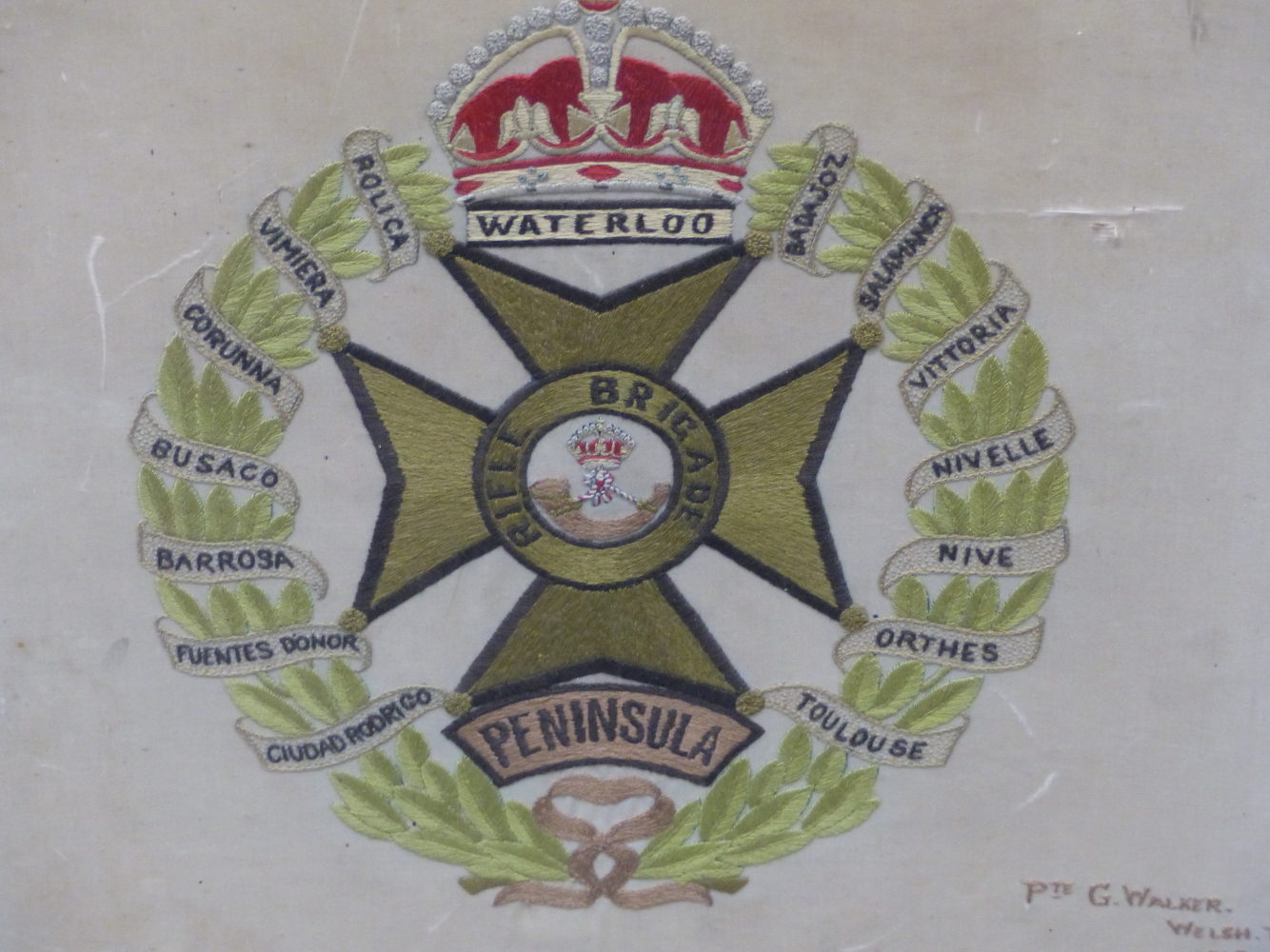 A SILK WORK RIFLE BRIGADE BADGE EMBROIDERED BY PRIVATE G WALKER OF THE WELSH REGIMENT 1918, THE