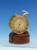 A VINTAGE AIR MINISTRY POCKET BAROMETER IN GILT BRASS CASE WITH LEATHER COVER.