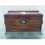 A REGENCY ROSEWOOD AND BRASS INLAID SARCOPHAGUS FORM TEA CADDY WITH BRASS RING HANDLES AND FEET. W.