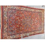 AN ANTIQUE PERSIAN RUG OF CLASSIC DESIGN 207 x 137cms.