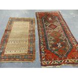 AN ANTIQUE CAUCASIAN RUG TOGETHER WITH AN ANTIQUE PERSIAN TRIBAL RUG 176 x 102cms AND 239 x 115cms.